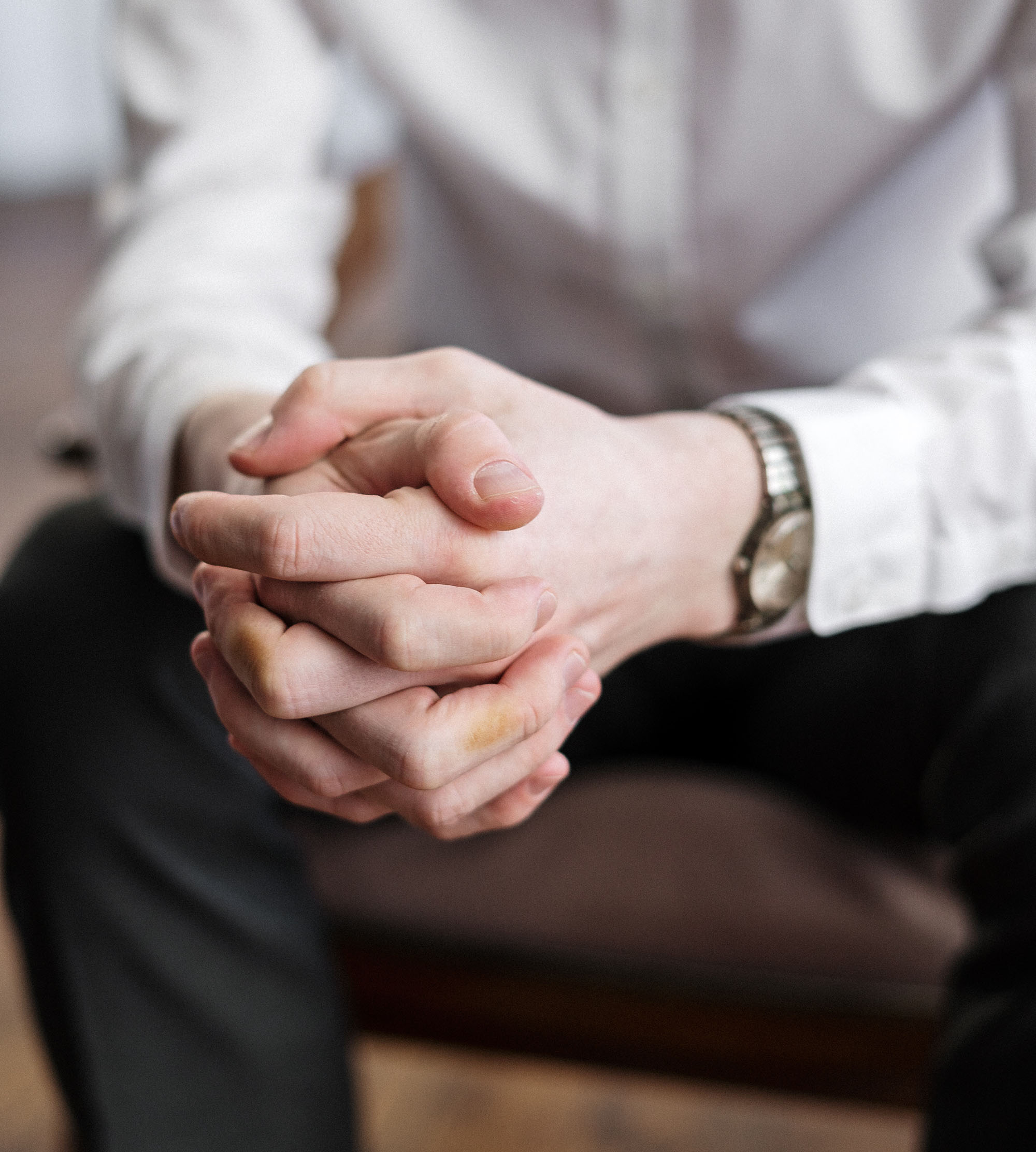 Close up of a man's clasped hands