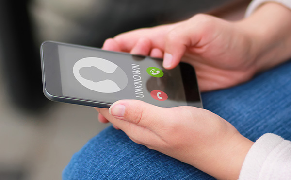 A photo of a phone receiving a call from 'unknown'.