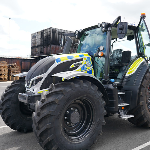 A tractor with high vis police markings.