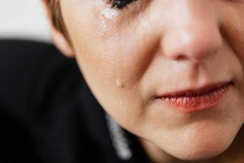Close up on lady's cheek with tear running down face