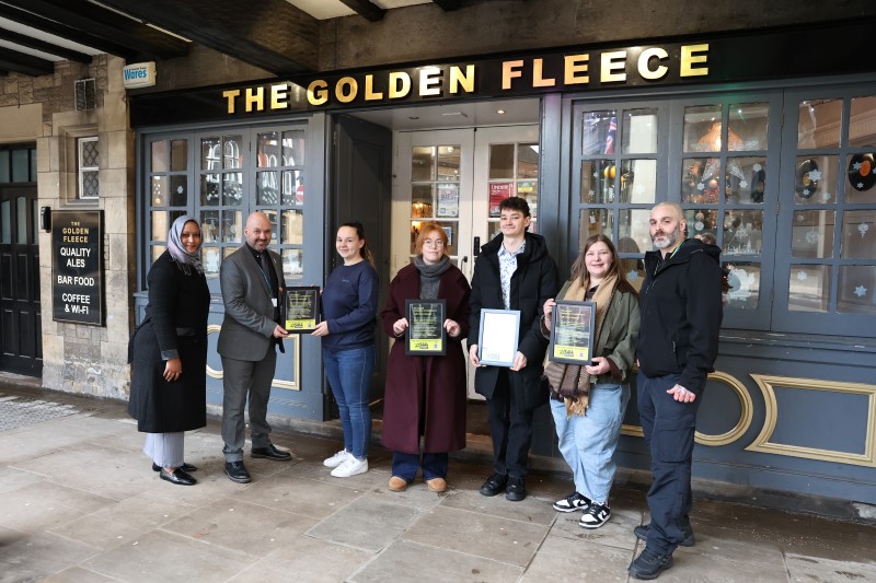 Partners outside pub pledging to Call It Out campaign