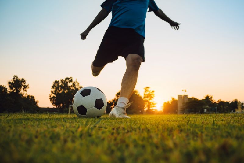 Close up of teenage boy playing football