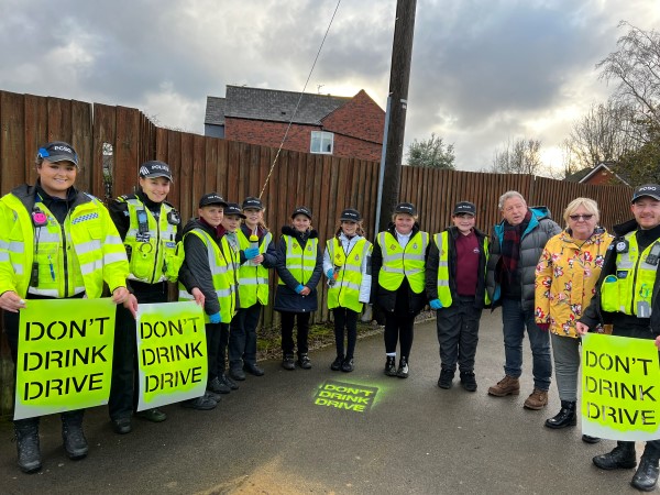 The Mini Police, stood with local councillors and the local police unit after spraying the words "Don't Drink Drive" outside of a pub.
