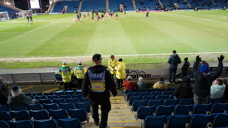 Officer walking down steps to football stadium