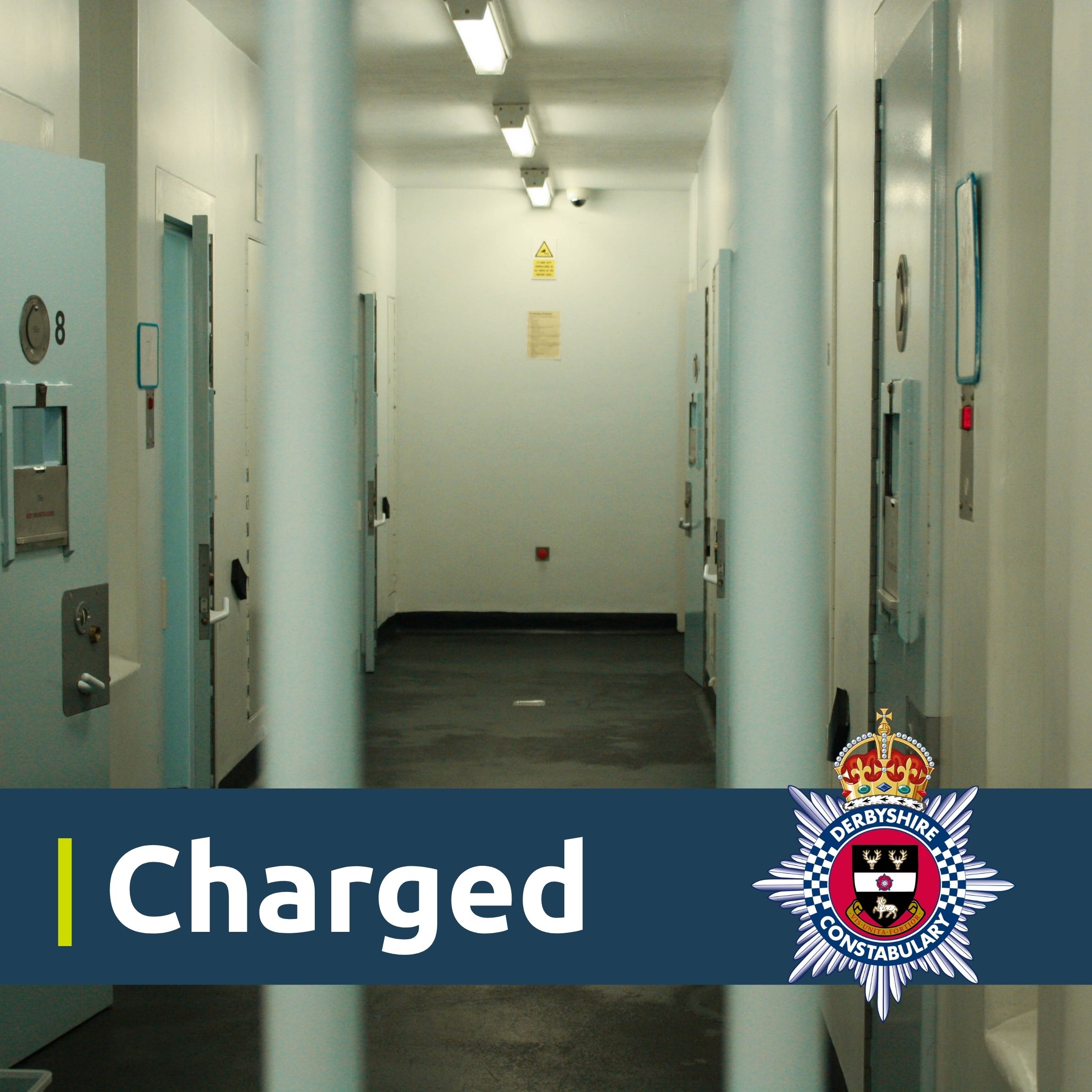 An image showing a custody cell. There is a blue banner located towards the bottom with the constabulary crest and the wording charged.