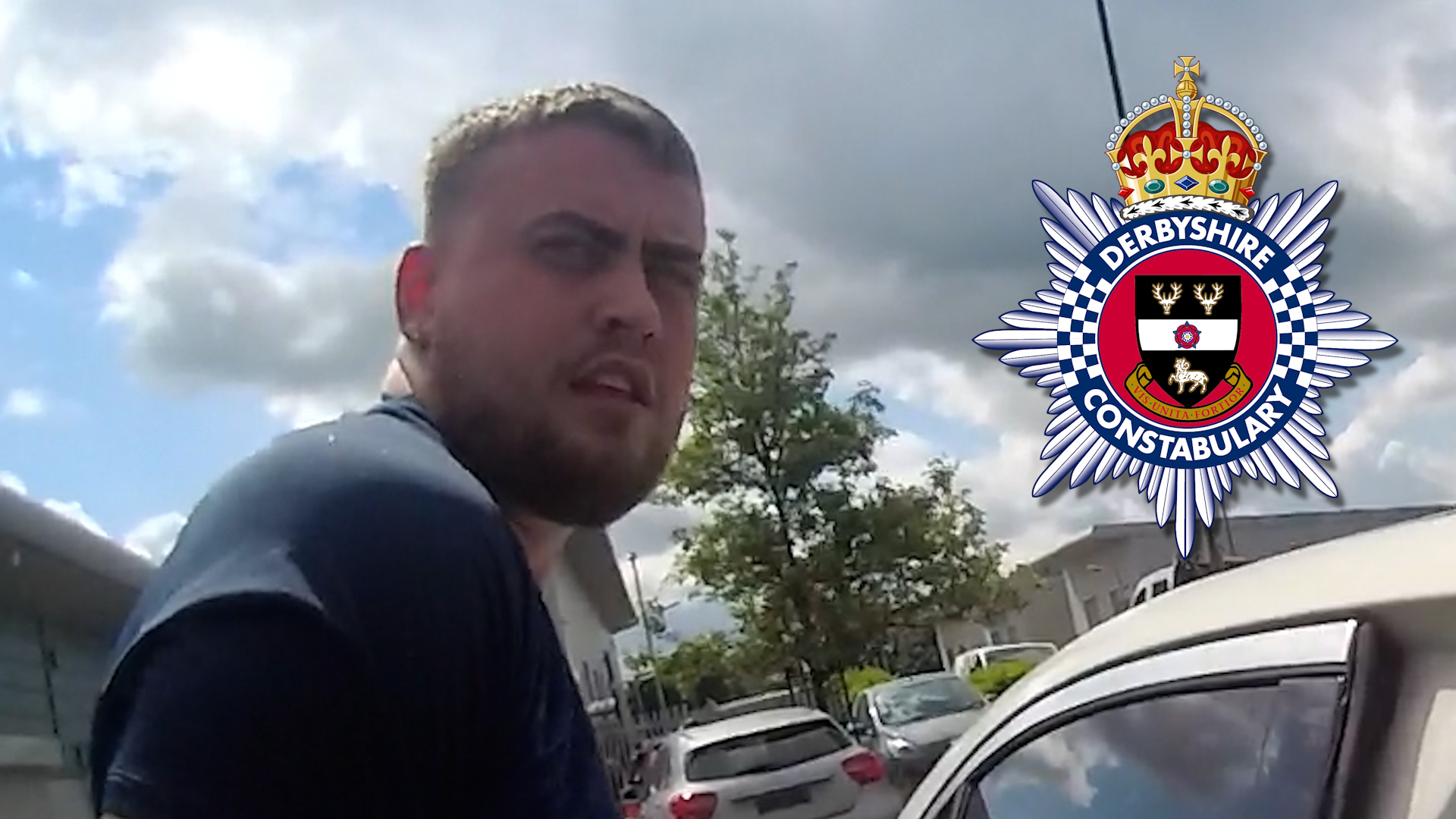 Joshua Newbould is shown looking towards camera after being arrested.