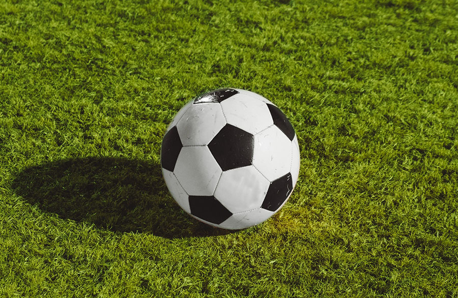 Football on grass pitch